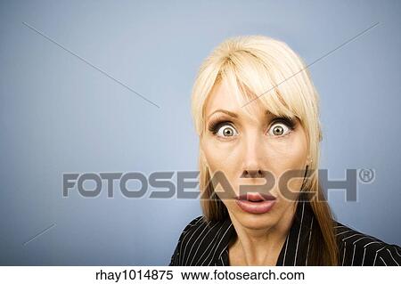 Stock Photography - Businesswoman in a pinstripe suit making a funny face. Fotosearch