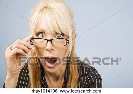 Businesswoman looking over the top of her glasses View Large Photo Image Stock Photograph - Businesswoman looking over the top of her glasses. Fotosearch