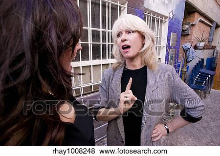 Businesswoman talking and gesturing in an alley View Large Photo Image Stock Photo - Businesswoman talking and gesturing in an alley. Fotosearch