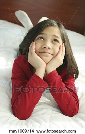 Child lying on bed thinking View Large Photo Image Picture - Child lying on bed thinking. Fotosearch