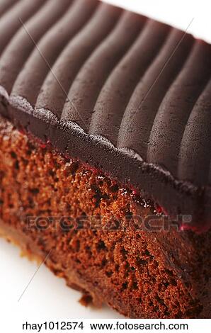 Chocolate cake with red jelly on the coffee table View Large Photo Image Picture - Chocolate cake with red jelly on the coffee table. Fotosearch