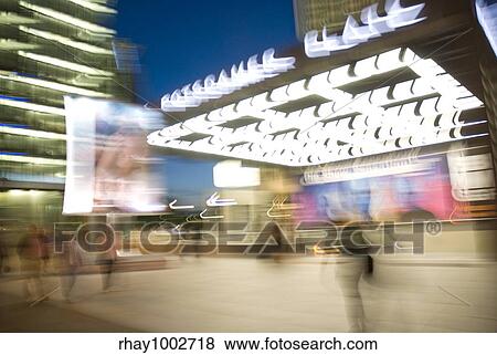 "City landscape, skyscraper and people with evening illuminationCity landscape, skyscraper and people with evening illumination" View Large Photo Image Stock Photo - "City landscape, skyscraper and people with evening illuminationCity landscape, skyscraper and people with evening illumination". Fotosearch