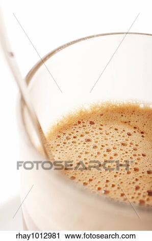 Stock Image - Close-up of a Glass of Hot chocolate with foam . Fotosearch