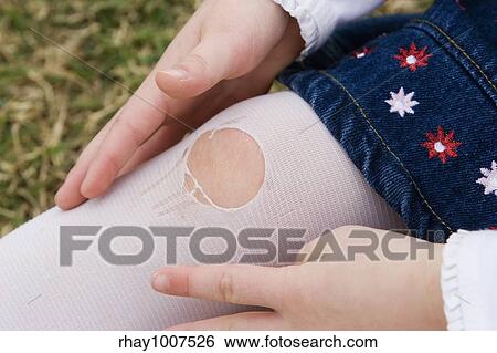 Close up of a little girl's knee with a hole ripped in her stocking. View Large Photo Image Stock Photograph - Close up of a little girl's knee with a hole ripped in her stocking.. Fotosearch