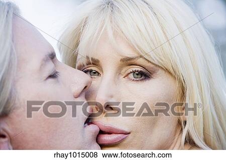 Close up of a pretty woman kissing a man View Large Photo Image Stock Photo - Close up of a pretty woman kissing a man. Fotosearch