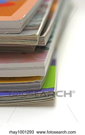 Close up of a stack of magazines on a white coffee table. View Large Photo Image Stock Image - Close up of a stack of magazines on a white coffee table.. Fotosearch
