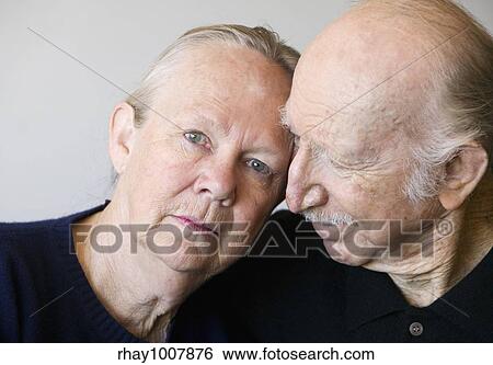 Stock Photograph - Close-up of senior couple focusing on worried woman. Fotosearch