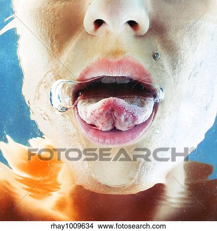 close-up of young woman's face with tongue out under water View Large Photo Image Picture - close-up of young woman's face with tongue out under water. Fotosearch