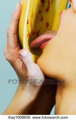 close up portrait of a woman cleaning up a plate with her tongue View Large Photo Image Stock Image - close up portrait of a woman cleaning up a plate with her tongue. Fotosearch