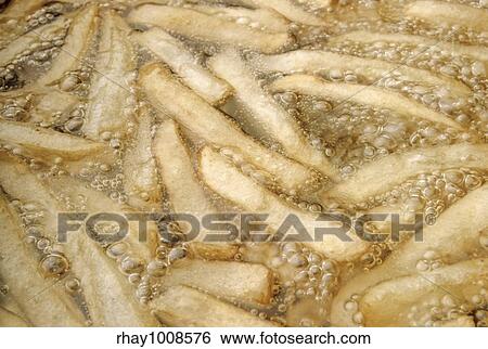Close up view of potatoes frying in oil View Large Photo Image Stock Photograph - Close up view of potatoes frying in oil . Fotosearch