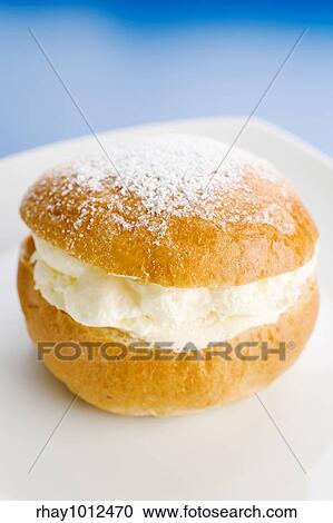 Stock Image - Creamy dessert on the plate over a blue background. Fotosearch