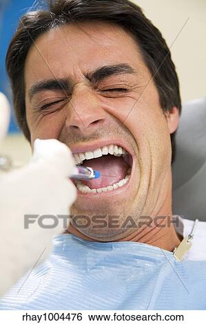 dentist holding a syringe and anesthetizing his patient View Large Photo Image Stock Photograph - dentist holding a syringe and anesthetizing his patient. Fotosearch