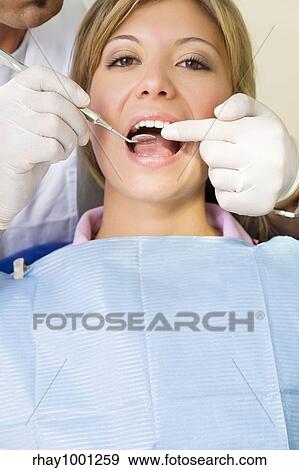 dentist using an angled mirror. Copy space. The focus is on woman's teeth View Large Photo Image Stock Photo - dentist using an angled mirror. Copy space. The focus is on woman's teeth. Fotosearch