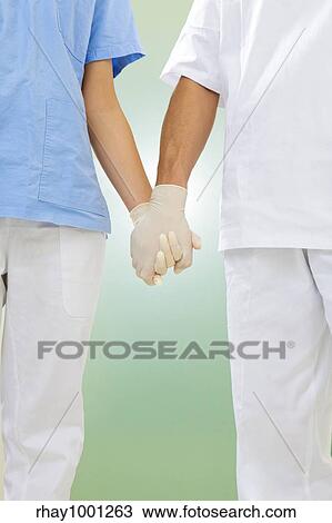 doctor and nurse holding hands in the hospital View Large Photo Image Stock Image - doctor and nurse holding hands in the hospital. Fotosearch