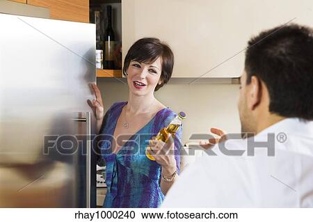 Stock Image - domestic life: friends sharing a beer. Fotosearch