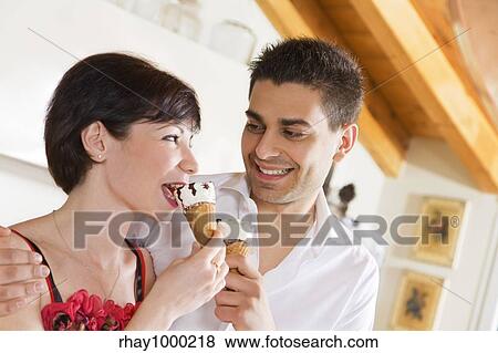 domestic life: happy couple eating an ice cream View Large Photo Image Stock Photo - domestic life: happy couple eating an ice cream. Fotosearch