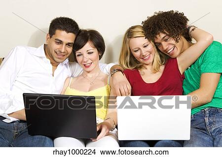 Picture - domestic life: two couples using laptops. Fotosearch