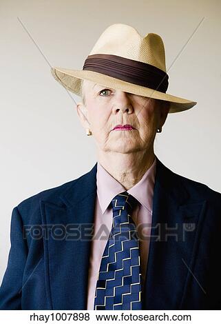 Dramatic senior woman in a man's suit wearing a straw gangster hat View Large Photo Image Stock Photo - Dramatic senior woman in a man's suit wearing a straw gangster hat. Fotosearch