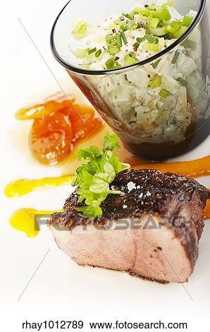 Stock Photo - Duck fillet and carrot mousse on the plate with side dish. Fotosearch