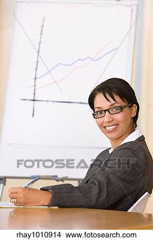 european female in office in front of flip chart View Large Photo Image Picture - european female in office in front of flip chart. Fotosearch