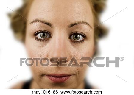Stock Photograph - Extreme closeup of a young woman in front of white background. Fotosearch