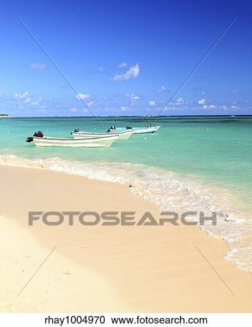 Fishing boats in Caribbean sea anchored near sandy beach View Large Photo Image Stock Image - Fishing boats in Caribbean sea anchored near sandy beach. Fotosearch
