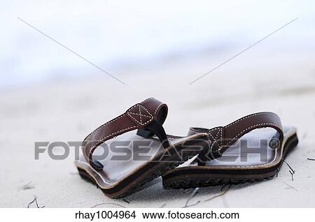 Picture - Flipflops on a sandy ocean beach - summer vacation concept. Fotosearch