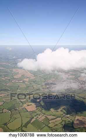 Flying high above a white cloud and the British countryside. View Large Photo Image Stock Photo - Flying high above a white cloud and the British countryside.. Fotosearch