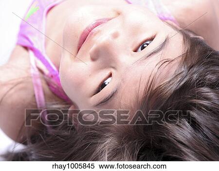 "Girl looking upside down at camera, part Scandinavian part Thai background" View Large Photo Image Stock Photography - "Girl looking upside down at camera, part Scandinavian part Thai background". Fotosearch
