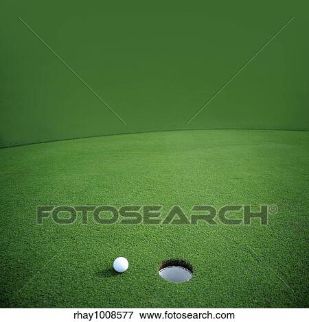 Golf ball falls just short of it's goal View Large Photo Image Stock Photo - Golf ball falls just short of it's goal. Fotosearch