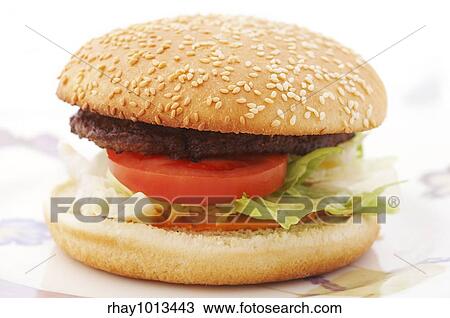Hamburger with tomato and lettuce on the plate View Large Photo Image Stock Image - Hamburger with tomato and lettuce on the plate. Fotosearch