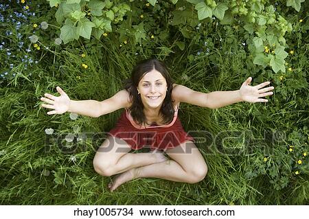 Picture - Happy girl smiling and lifting hands upwards Happy girl smiling and lifting hands upwards . Fotosearch