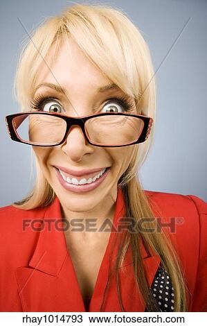 Stock Image - Happy woman wearing glasses in red with a big smile. Fotosearch