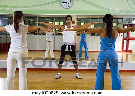 health club: man and women doing stretching and aerobics View Large Photo Image Stock Photo - health club: man and women doing stretching and aerobics. Fotosearch