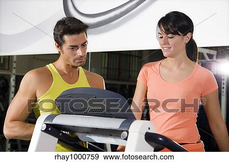 health club: woman walking on a tapis roulant with her personal trainer View Large Photo Image Stock Photo - health club: woman walking on a tapis roulant with her personal trainer. Fotosearch