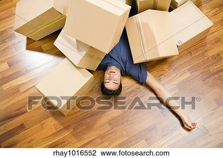High angle view of young man sleeping underneath moving boxes View Large Photo Image Stock Image - High angle view of young man sleeping underneath moving boxes. Fotosearch