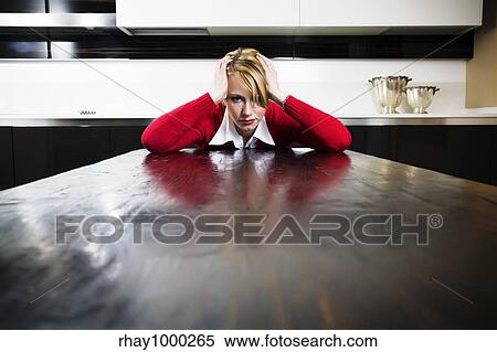 Stock Photography - home life: desperate housewife with hands on head. Fotosearch