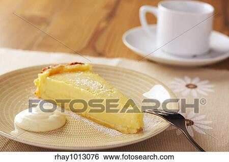 Home made icing sugar topped lime tart with cream on wooden table View Large Photo Image Stock Photograph - Home made icing sugar topped lime tart with cream on wooden table. Fotosearch