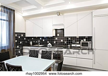 Interior of the modern kitchen with a table and chairsInterior of the modern kitchen with a table and chairs View Large Photo Image Picture - Interior of the modern kitchen with a table and chairsInterior of the modern kitchen with a table and chairs. Fotosearch