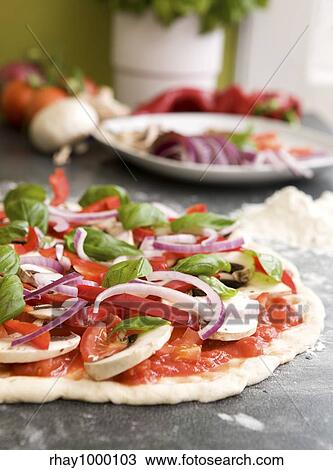 Italian style vegetarian pizza on the counter waiting to be baked. View Large Photo Image Stock Image - Italian style vegetarian pizza on the counter waiting to be baked.. Fotosearch