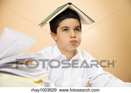 little boy getting bored of doing homeworks View Large Photo Image Stock Photo - little boy getting bored of doing homeworks. Fotosearch