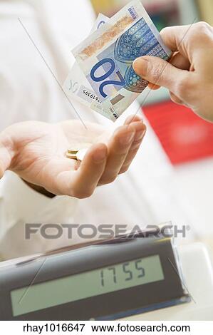 man at the supermarket paying 20 Euro to the cashier View Large Photo Image Stock Photo - man at the supermarket paying 20 Euro to the cashier. Fotosearch
