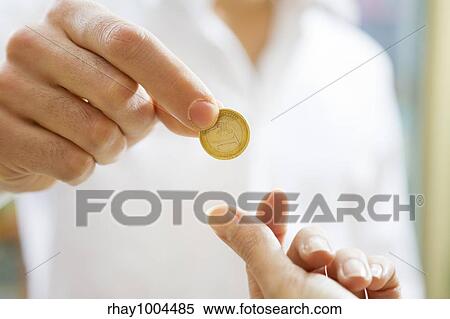 man paying 1 euro to the cashier in a store. Close up of the coin and some copy space View Large Photo Image Stock Photography - man paying 1 euro to the cashier in a store. Close up of the coin and some copy space. Fotosearch