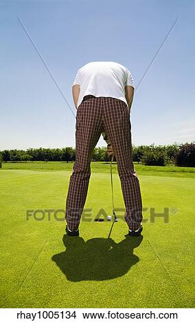 man putting golf ball View Large Photo Image Picture - man putting golf ball. Fotosearch