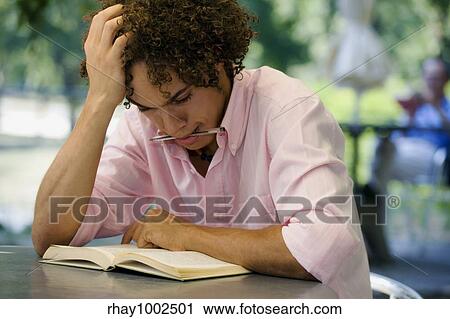 Stock Image - man reading outside. Fotosearch