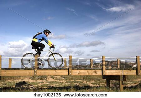 Man riding a bike in a beautiful day View Large Photo Image Stock Photography - Man riding a bike in a beautiful day. Fotosearch