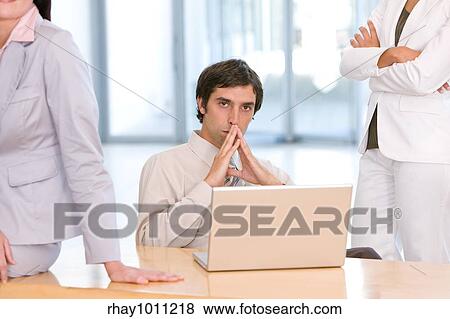 man sitting at laptop in office View Large Photo Image Stock Photo - man sitting at laptop in office. Fotosearch