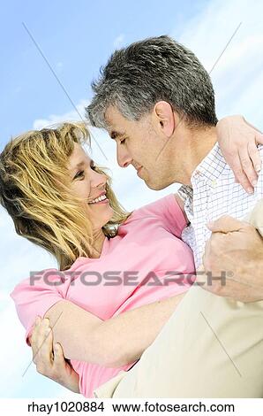 Mature romantic couple of baby boomers enjoying outdoors View Large Photo Image Picture - Mature romantic couple of baby boomers enjoying outdoors. Fotosearch