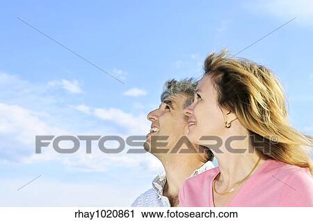 Mature romantic couple of baby boomers looking at the sky View Large Photo Image Stock Image - Mature romantic couple of baby boomers looking at the sky. Fotosearch
