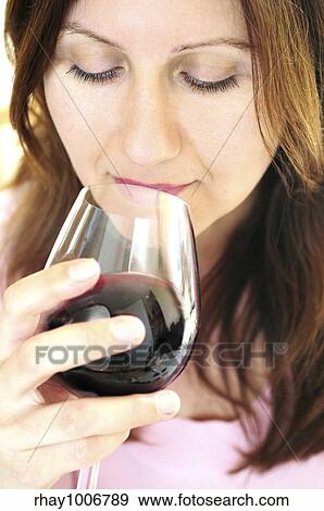 Mature woman holding a glass of red wine View Large Photo Image Stock Photo - Mature woman holding a glass of red wine. Fotosearch